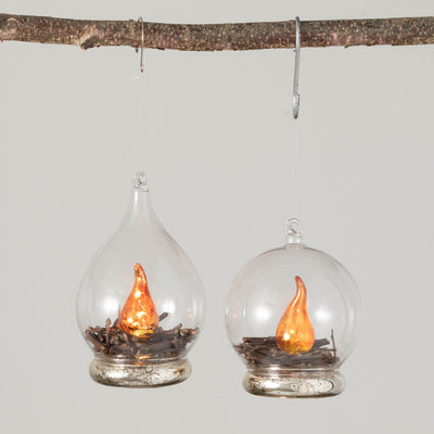 woodland campfires encased in glass drop ornaments. These hand-blown glass Christmas ornaments are a perfect way to light up the night with a battery operated flickering frame. Available at Davis Porch and Patio Weatherford Texas