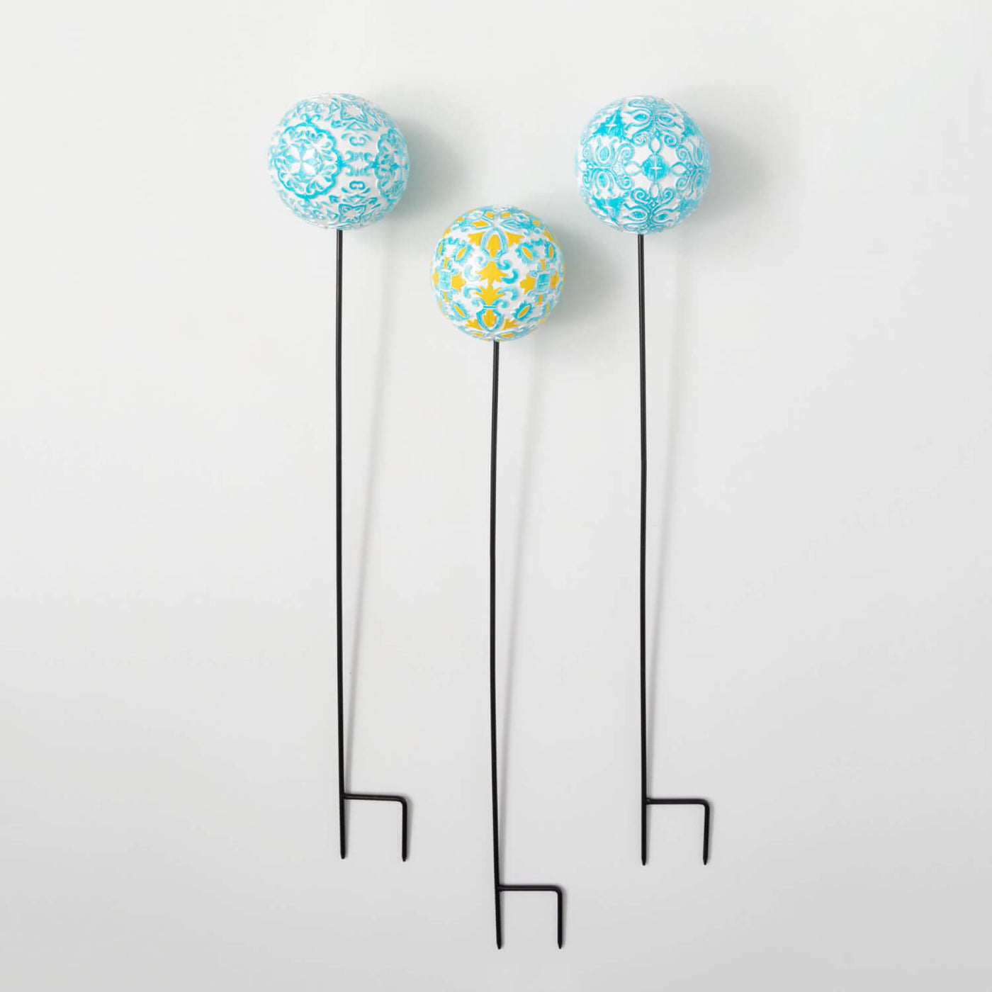Set of 3 orb gardens stakes with various designs of blue, white, and yellow