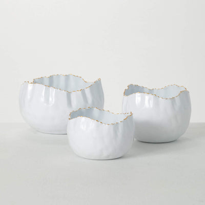 Assortment of three white metal bowls with organic gold brushed edge