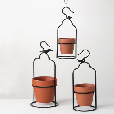 Set of three terracotta pots in hanging metal frames with bird accent