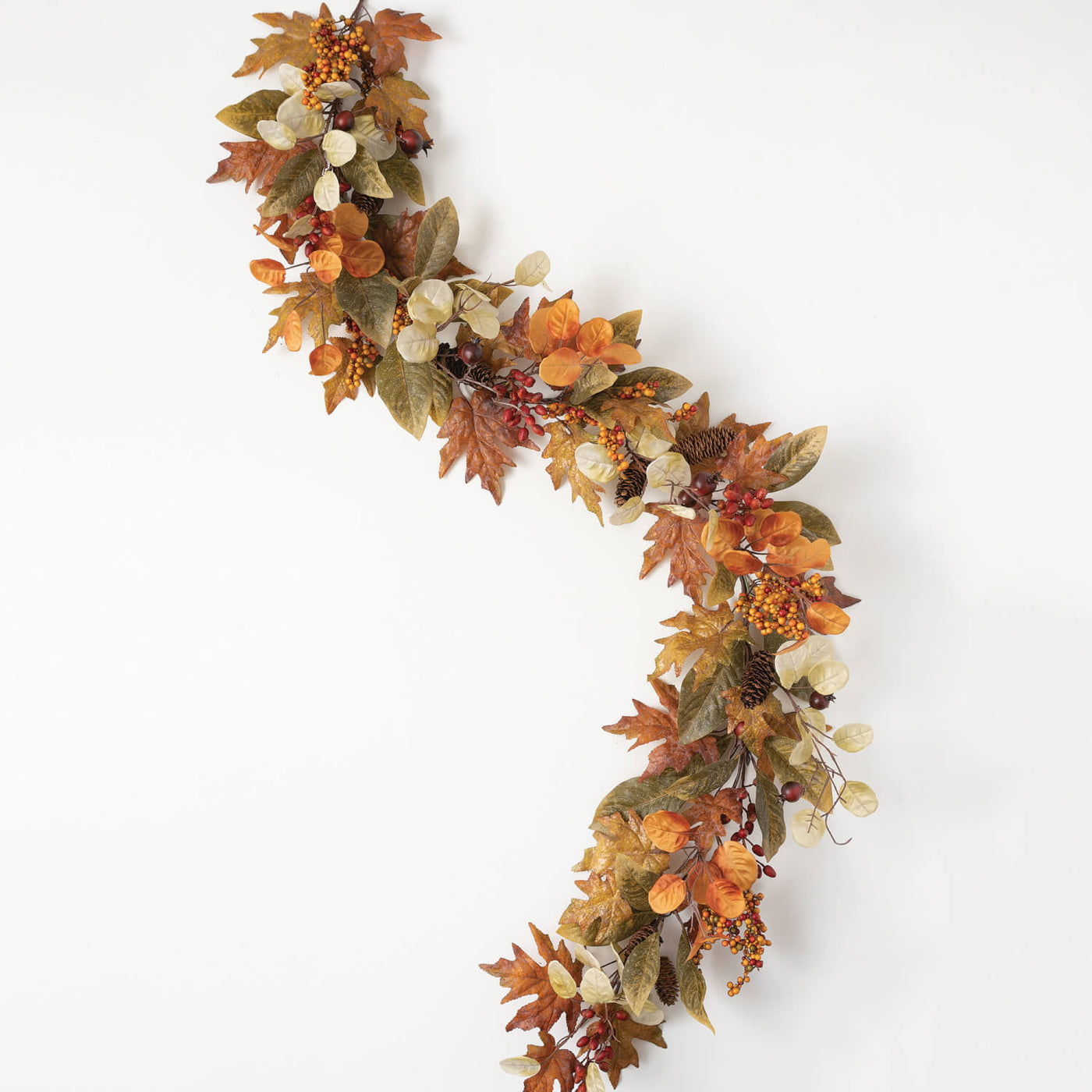 Garland of mixed fall leaves, berries, and pine cones
