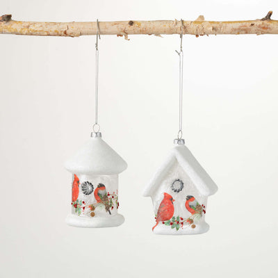 White glasss ornaments decayed with red cardinals and holly accents