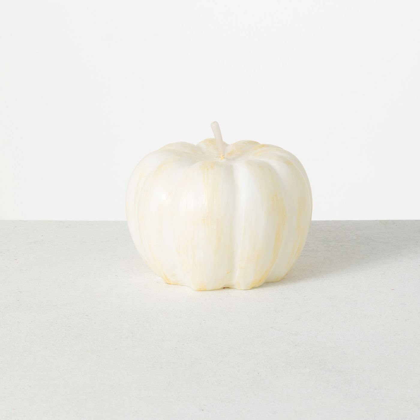 6 inch Vance Kitira white pumpkin candle with brushed gold accents