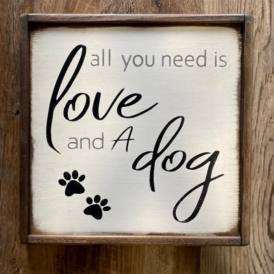 Wood sign reads all you need is love and a dog
