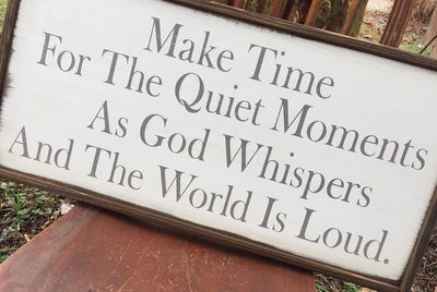 Handmade wooden sign reads Make Time For The Quiet Moments As God Whispers And The World Is Loud.