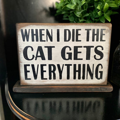 Handmade wood sign on wood base reads When I die the Cate Gets Everything
