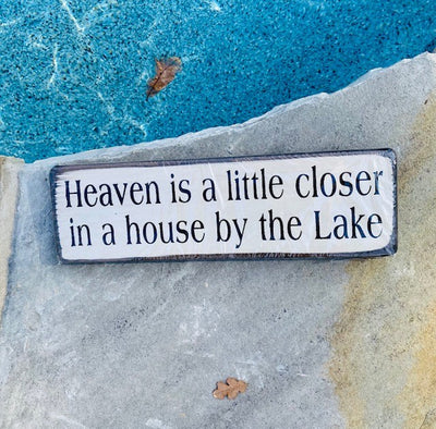 handmade wood sign reads Heaven is a little closer in a house by the Lake