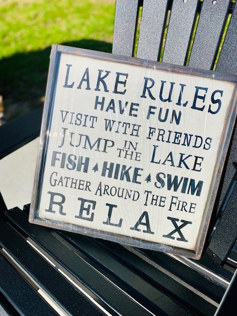 Wood Sign reads Lake Rules, Have Fun, Visit with Friends, Jump in the lake, Fish, Hike, Swim, Gather around the fire, RELAX! 