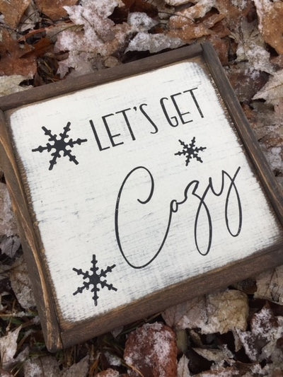 Hand painted wooden sign reads Let's Get Cozy.
