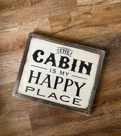 Handmade wood sign reads The Cabin Is My Happy Place