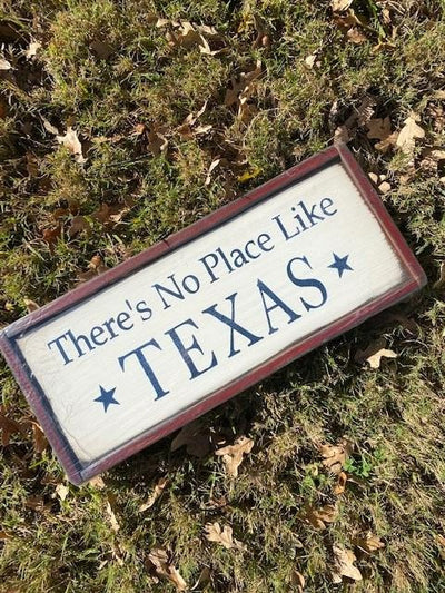 Handmade wood sign reads There’s No Place Like Texas