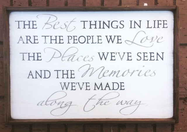 Handmade wood sign reads The best things in life are the people we love, the places we’ve seen, and the memories we’ve made along the way. 