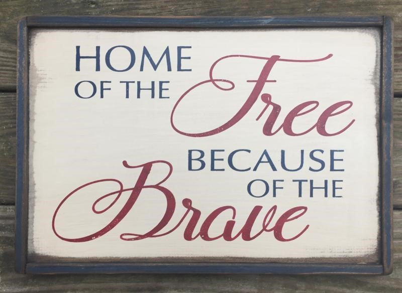 Wood sign reads home of the free because of the brave