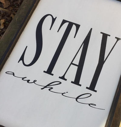 Handmade sign reads Stay Awhile