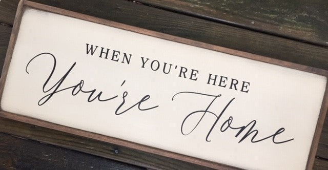 Solid wood sign reads When You’re Here You’re Home